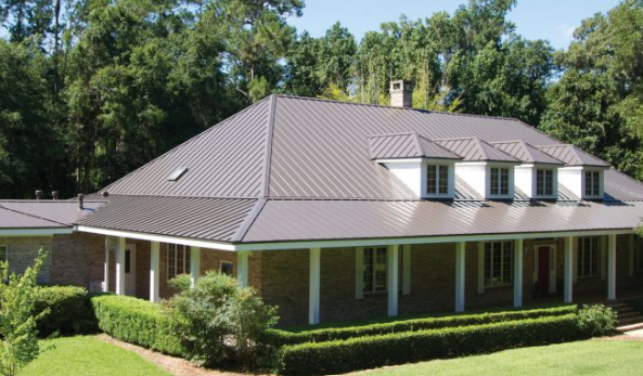 Stone house dark metal roof completed