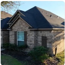 Brick house black shingles completed roof