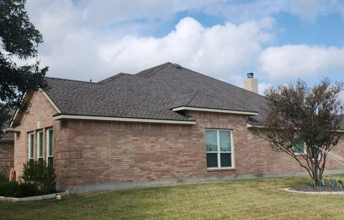 Brick house charcoal shingles completed roof